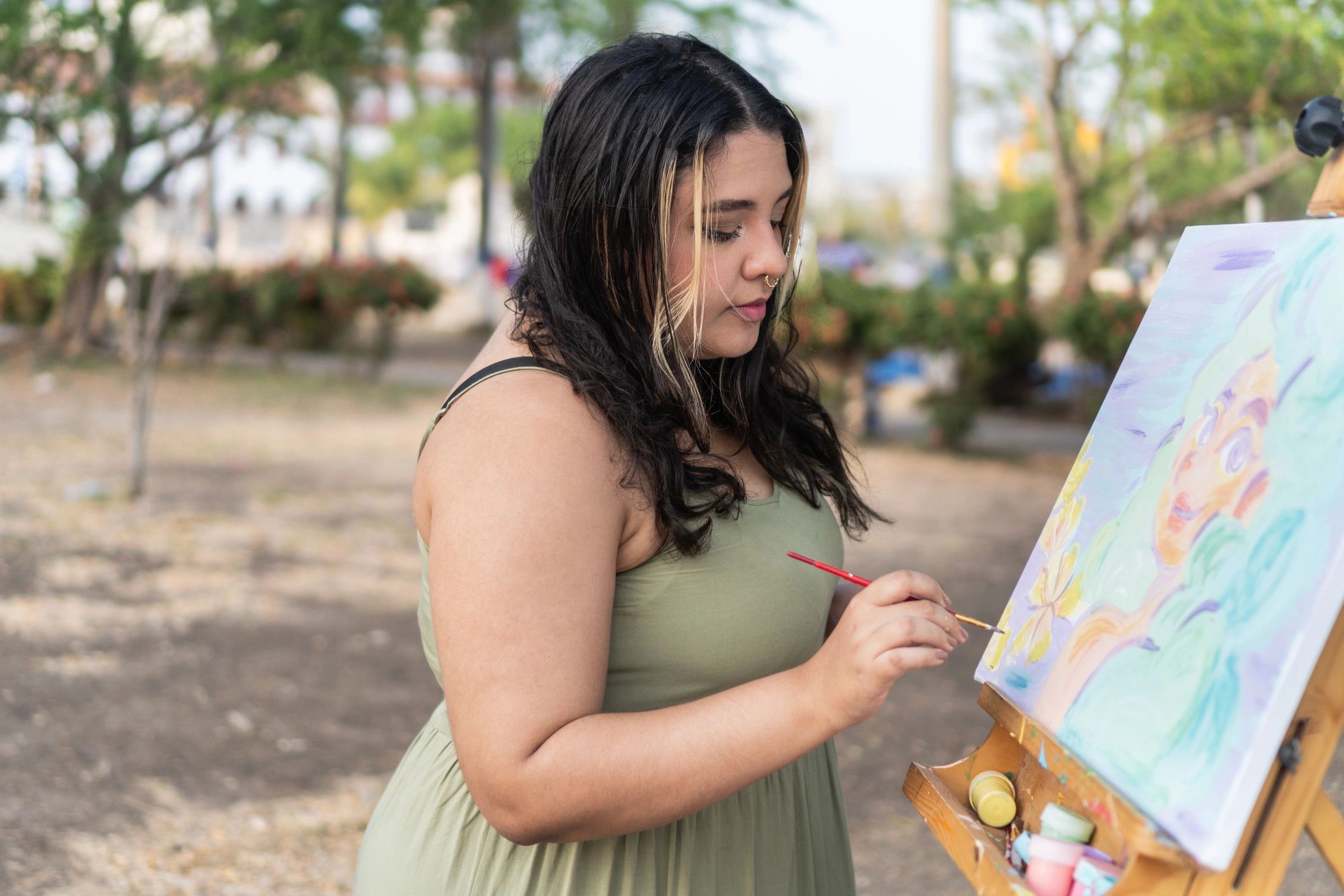 Woman painting outdoors in a peaceful garden setting